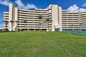 ein großes Gebäude mit einer Rasenfläche davor in der Unterkunft Cozy Condo with Gulf View, Bird Watching and Telescope in Hudson