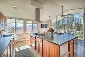 a kitchen with a large island in a kitchen with windows at Pristine West Dover Home with Deck and Mountain Views! in West Dover