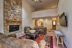 un grand salon avec une grande cheminée en pierre dans l'établissement House with Game Room, 5 Miles to Downtown Flagstaff!, à Flagstaff