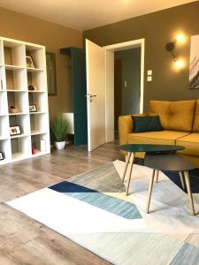 a living room with a yellow couch and a table at Four in Koblenz