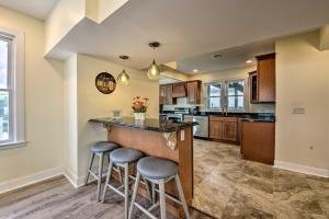 a kitchen with a bar with stools in it at Seaside Wildwood Haven Walk to Boardwalk and Beach! in Wildwood Crest