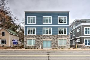 a blue building on the side of a street at Modern Michigan Condo about 1 Mi to Grand Traverse Bay in Traverse City