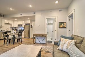 a living room with a couch and a table at Modern Michigan Condo about 1 Mi to Grand Traverse Bay in Traverse City