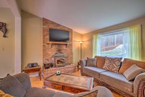 a living room with a couch and a fireplace at Quiet Catskills Getaway with Deck-Panoramic Mtn Views in New Kingston