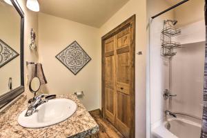 a bathroom with a sink and a wooden door at McJuggers Loft Walk to Lake, Park, Restaurants in Campbellsport