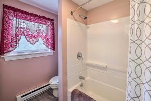 a bathroom with a tub and a toilet and a window at Quiet Catskills Getaway w/ Deck & Mtn Views in New Kingston +23 photos