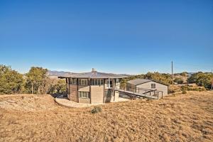 a house on top of a hill in a field at Sierra Blanca Mountain Retreat 16 Miles to Ruidoso in Nogal