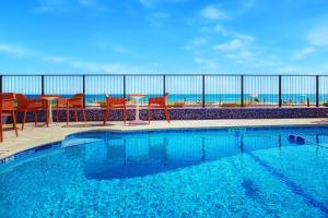 a swimming pool filled with lots of blue water at Ocean Treasure Beachside Suites in Fort Lauderdale