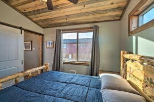 a bedroom with a blue bed and a window at Romantic Mountain Getaway - 1 Hour to Yellowstone! in Livingston