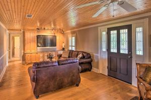 a living room with a couch and a tv at Serving Southern Charm at this Clarkesville House! in Clarkesville
