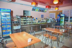 a fast food restaurant with tables and a counter at Forsage in Rivne