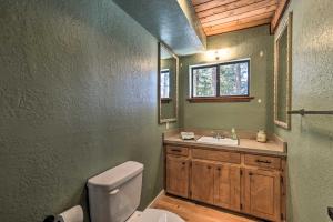 a bathroom with a toilet and a sink and a window at Angel Fire Cabin Less Than 3 Miles to Skiing, Golf and Lake in Angel Fire +18 photos