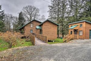 a log cabin with a wooden ramp leading to a house at Scenic Log Cabin with Fire Pit and Stocked Creek! in Titusville