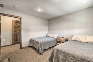a bedroom with two beds and a mirror at Kansas Hunting Lodge Pets and Large Groups Welcome! in Great Bend