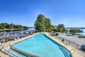 a pool with chairs and umbrellas next to a river at Lake Keowee Resort Condo Pool, Beach, Golf Access in Salem