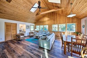 a living room with wooden ceilings and a table at Bright Southern Shores Family Home Less Than 1 Mi to Beach in Southern Shores