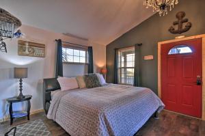 a bedroom with a bed and a red door at Coastal Retreat in Long Beach Walk to Attractions in Long Beach