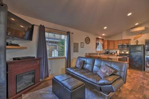 a living room with a leather couch and a fireplace at Coastal Retreat in Long Beach Walk to Attractions in Long Beach