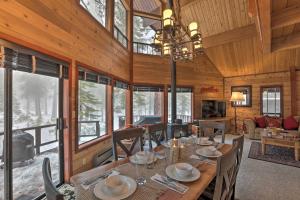 a dining room with a table and chairs and windows at 2 Mi to Northstar Resort Idyllic Cabin with Shuttle in Truckee