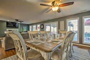 a dining room with a table with chairs and a ceiling fan at Bayview Lake House with Dock on Lake of the Ozarks in Lake Ozark