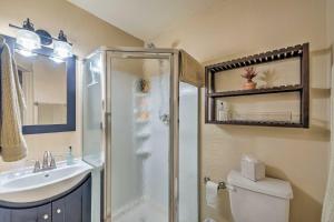 a bathroom with a shower and a toilet and a sink at Condo on Golf Course 2 Mi to Grindstone Lake! in Ruidoso