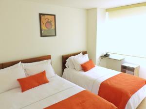 Postel nebo postele na pokoji v ubytování Hotel Portal de los Andes