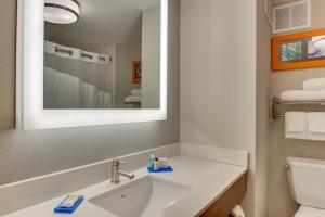 a bathroom with a sink and a mirror at Holiday Inn Express & Suites Atlanta Perimeter Mall Hotel by IHG in Sandy Springs
