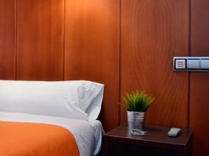 Postel nebo postele na pokoji v ubytování Hostal Bajo La Muralla