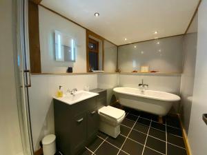 a bathroom with a sink and a tub and a toilet at Tigh a Chabar in Lochaline