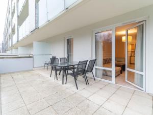 a balcony with a table and chairs on it at AquaBaltic Apartments Aquarius in Kołobrzeg
