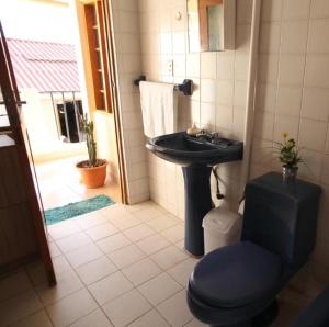 a bathroom with a sink and a toilet at Casa Los Jazmines in Sucre