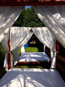 a canopy bed in a field of grass at Szent Kristof Panzio in Vonyarcvashegy