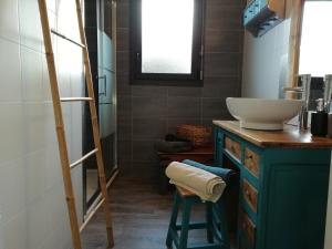 a bathroom with a sink and a mirror and a ladder at les roches du Cabellou 150M de la mer in Concarneau