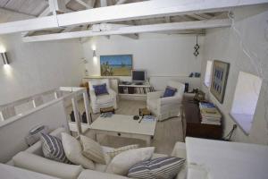 a living room with white furniture and a desk at Beautiful Dollhouse in Hydra in Hydra