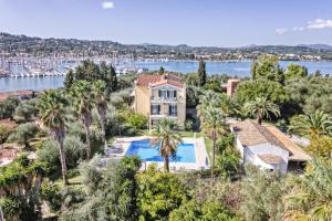 an aerial view of a house with a swimming pool and palm trees at Villa Eftichia Hotel Apartments & Studios in Kontokali