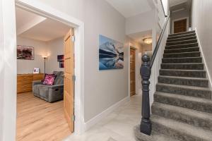 a staircase leading to a living room with a couch at Park View - 4 Star Luxury in Belfast