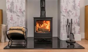 a living room with a fireplace and a chair at Park View - 4 Star Luxury in Belfast