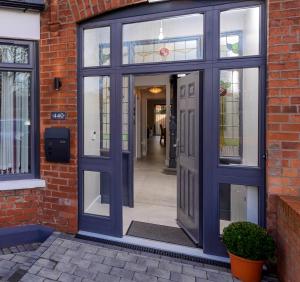 an entrance to a brick building with a blue door at Park View - 4 Star Luxury in Belfast