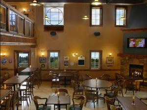 a restaurant with tables and chairs and a fireplace at Jordan House Hotel in Jordan