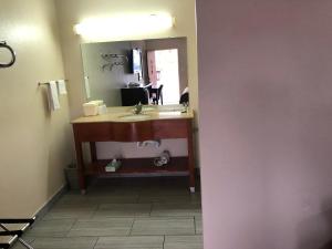 a bathroom with a sink and a mirror at Crossroads Inn in Lebanon