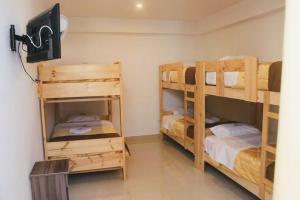 a room with two bunk beds in a room at Hotel Ocean Beach Paracas in Paracas