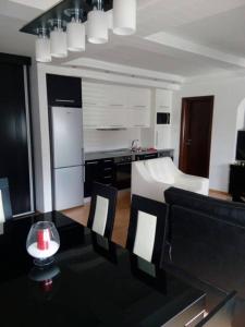 a kitchen with a table and chairs in a room at Brand New Apt in City Center in Bitola