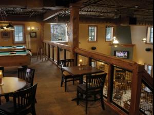 a restaurant with tables and a pool table at Jordan House Hotel in Jordan