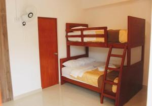 a bedroom with bunk beds with a bed and a ladder at Hotel Ocean Beach Paracas in Paracas +19 photos