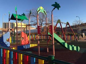 a playground with a slide in a park at Casa rural Vega alta in Madridejos