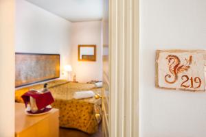En eller flere senger på et rom på Hotel Garden
