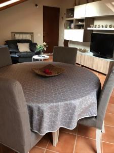 sala de estar con mesa y sofá en Mansarda Margherita, en Gozzano