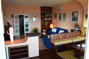 a living room with a blue couch and a fireplace at Apartment in Cala Gonone 26346 in Cala Gonone +15 photos