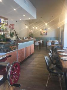 a restaurant with tables and chairs and a counter at Tui Beds in Arenzano