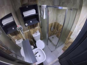 a bathroom with a shower and a toilet and a sink at Exporoyal Hotel in Antalya +53 photos